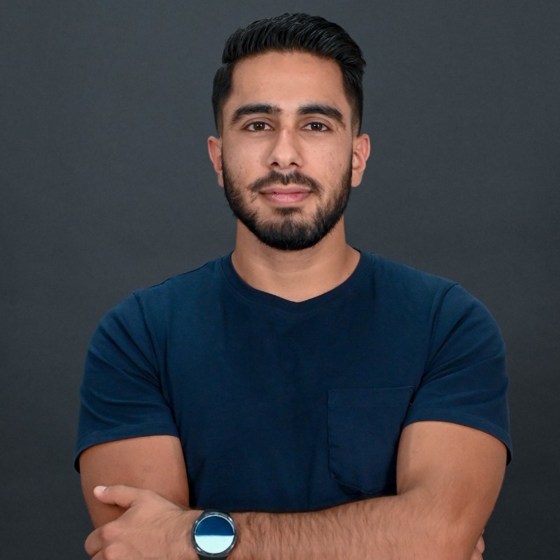 Floris Alexandrou slightly smiling in a red blue tshirt